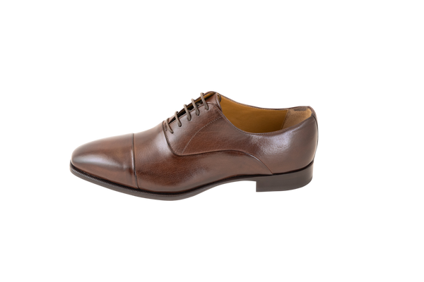 The classic men's leather Oxford shoe available in brown and black. Made from pure calf leather by our shoe artisans in Italy. Its sleek, elongated shape adds a modern touch to a classic design.
